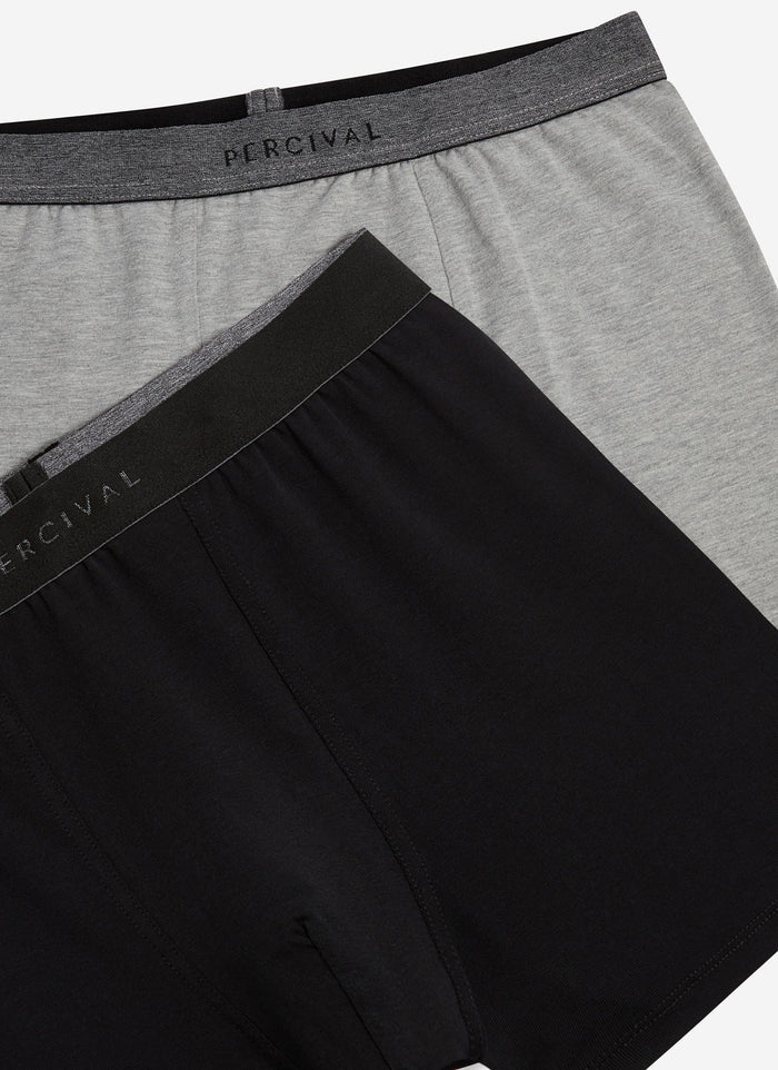 A close-up of the grey and black Percival cotton stretch trunks, focusing on the branded elasticated waistbands.