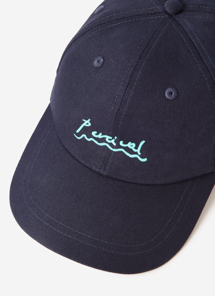 A close-up of the Percival Amor Embroidered Cap in navy, showing the detailed light blue logo stitching on the front.
