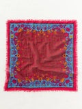 Burgundy bandana with vibrant teal and floral botanical print, frayed edges.