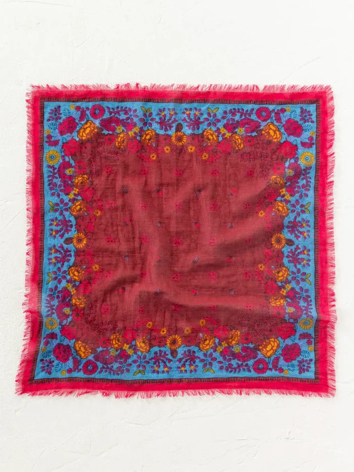 Burgundy bandana with vibrant teal and floral botanical print, frayed edges.