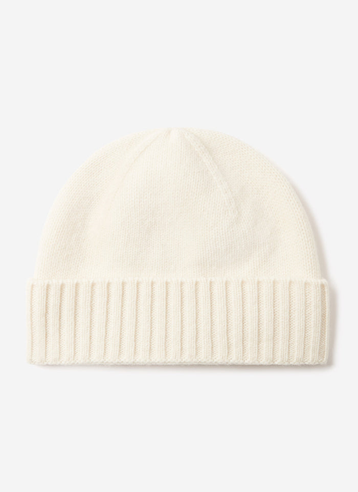 The Percival Wool Beanie in ecru, a classic ribbed knit with a folded cuff, photographed against a white background.