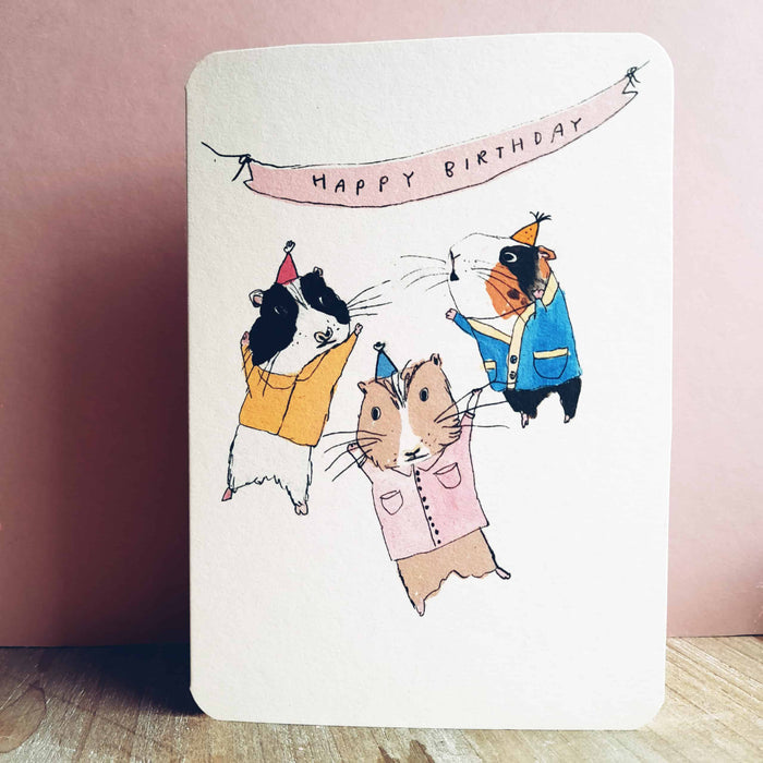 Birthday guinea pig party card with illustrated guinea pigs and “HAPPY BIRTHDAY” banner