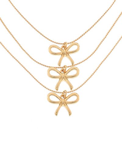 Gold bow pendant necklace with delicate layered chains, photographed for The Pink Doxie Boutique.