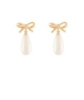 Gold bow earrings with teardrop faux pearl drops displayed on a white background from The Pink Doxie Boutique.