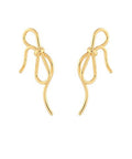 Gold bow and wavy tail earrings with a delicate flowing design displayed on a white background from The Pink Doxie Boutique.