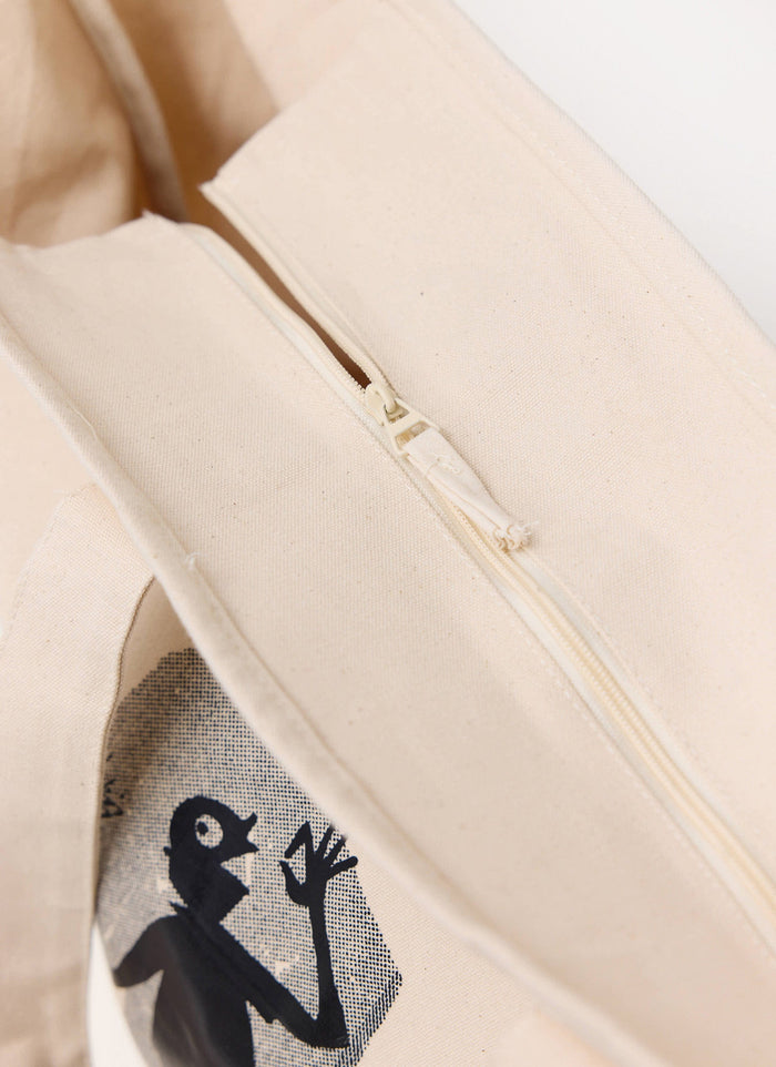 A close-up of the zip top detail on the ecru cotton Carlo Mixologist Tote Bag from Percival.