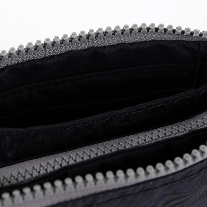 Medium recycled canvas zipper pouch interior, black lining and zipper teeth close-up