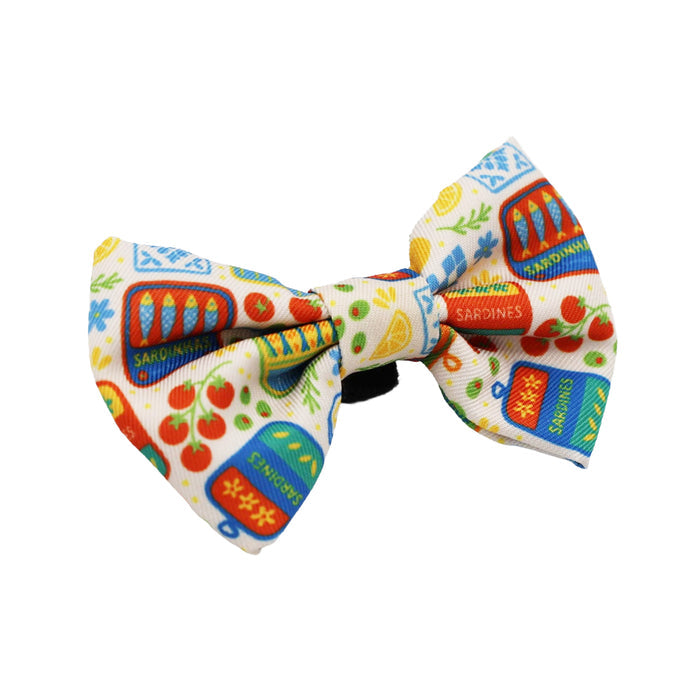 The Sassy Woof Cat Bowtie - Portofino features playful sardine cans, tomatoes, and lemons on white, ideal for accessorizing your cat's lightweight collar or harness.
