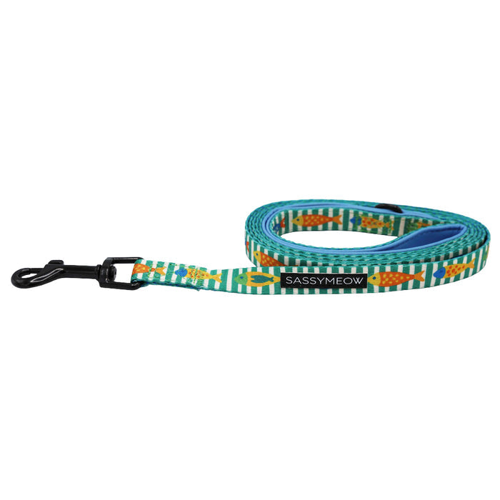 The Cat Bundle - Portofino by Sassy Woof features a colorful leash with a green, white, and orange fish pattern, black metal clasp, and brand name near the handle. Matches perfectly with an adjustable harness.