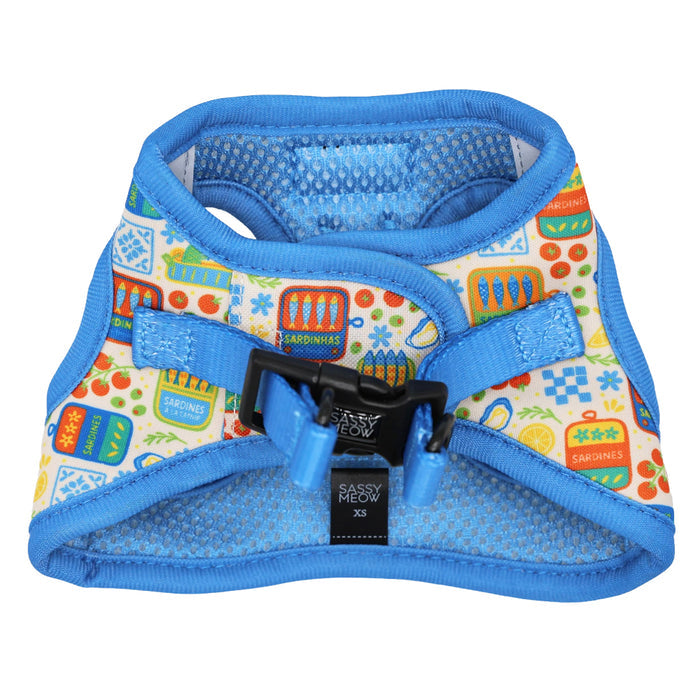 The Sassy Woof Cat Step-In Harness - Portofino features a playful sardine can, fish, and kitchen pattern with blue trim, black buckle, and breathable mesh lining. Part of the Portofino Cat Collection. Size XS.
