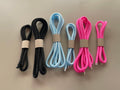 Cord set with braided cords in black, blue, and pink, with metal tips and loops