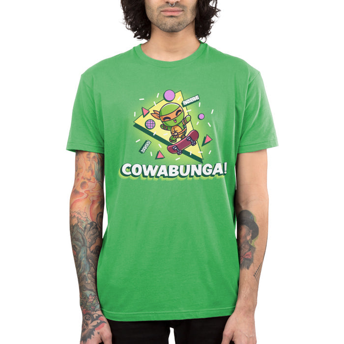 Premium Cotton T-shirt_TeeTurtle apple green Cowabunga! apparel featuring Michelangelo from Teenage Mutant Ninja Turtles on a skateboard with retro 90’s graphics in the background.