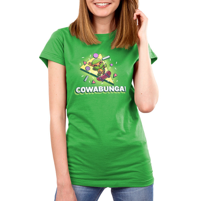 Premium Cotton T-shirt_TeeTurtle apple green Cowabunga! apparel featuring Michelangelo from Teenage Mutant Ninja Turtles on a skateboard with retro 90’s graphics in the background.