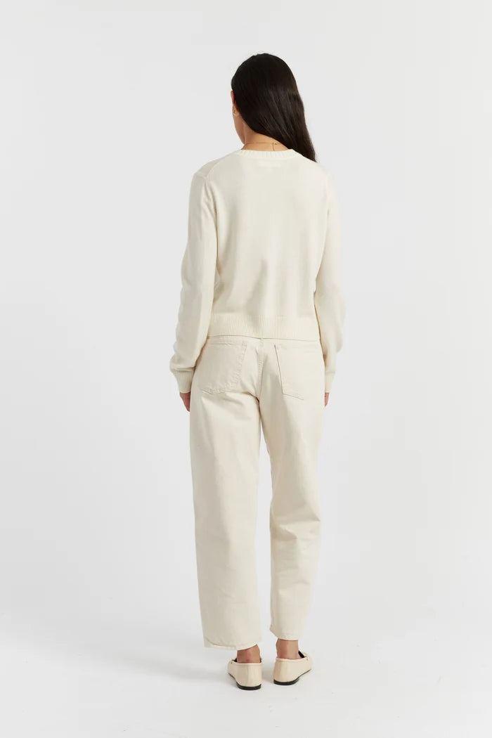 Person wearing a beige outfit on a white background