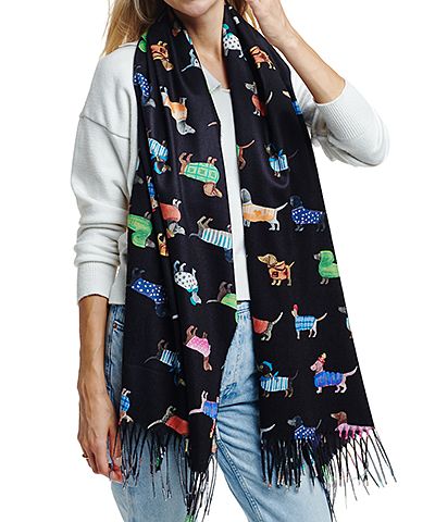 Person wearing a black scarf with colorful dog illustrations on a white background