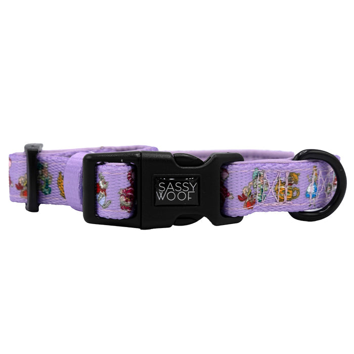 The Sassy Woof Dog Collar - Alice in Wonderland (Purple) features a lavender design with colorful Wonderland-inspired patterns and a black plastic buckle.