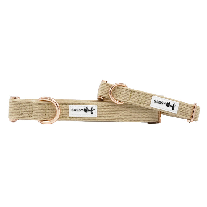 Two beige "Best Pup" dog collars by Sassy Woof, featuring rose gold hardware and adjustable corduroy design, are shown against a white background.