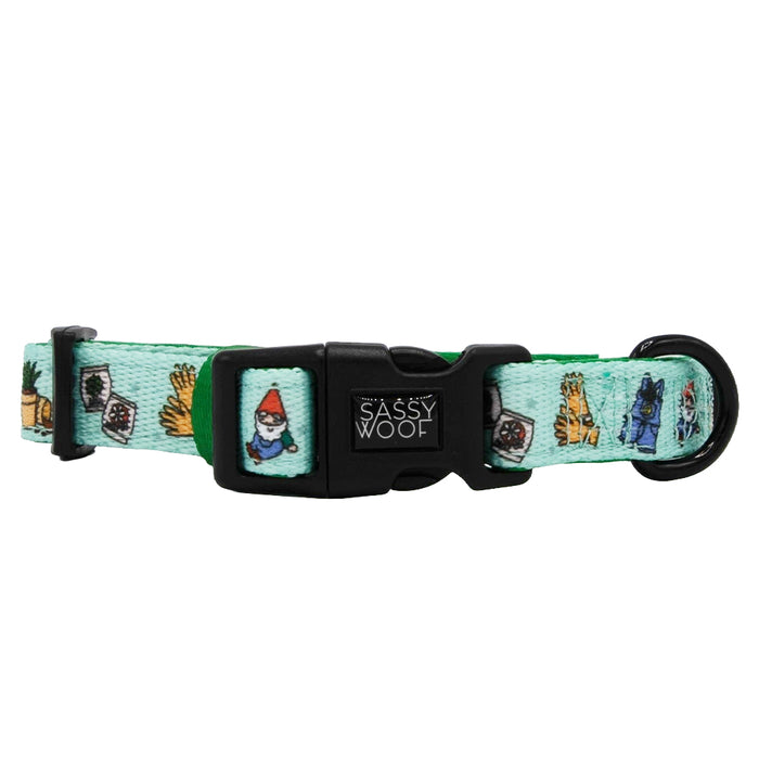 The Sassy Woof "Chillin with my Gnomies" dog collar is light green, adjustable, features gnomes, tarot cards, mystical objects, a plastic buckle with a Sassy Woof logo, and a leash attachment.