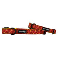 Two Sassy Woof "Lucky Dragon" dog collars with red and orange paisley patterns, black buckles and rings, plus a black Sassy Woof logo tag are shown on a white background.
