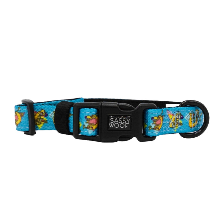 The Sassy Woof Dog Collar - Nickelodeon CatDog™ is blue neoprene with taco and heart designs, a black plastic buckle and loop, and "Sassy Woof" printed on the buckle for comfy, stylish flair.