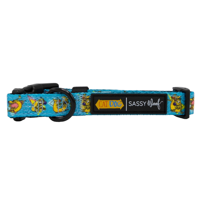 The Sassy Woof Dog Collar - Nickelodeon CatDog™ is a blue adjustable collar with cartoon cat and dog illustrations, a black buckle, a “Sassy Woof” label, and a yellow “Cat Dog” tag—fun and functional for your pup.