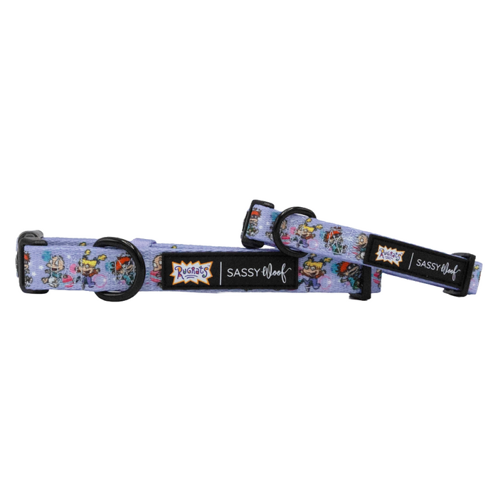 Two adjustable purple Dog Collar - Nickelodeon Rugrats™ by Sassy Woof, featuring Rugrats cartoon characters, black buckles, and “Rugrats” and “Sassy Woof” logos—perfect for fans of 90s-inspired dog accessories.