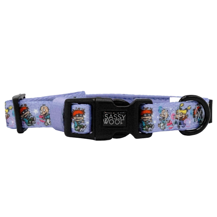 The Sassy Woof Dog Collar - Nickelodeon Rugrats™ features colorful cartoon characters, a purple design, and a black plastic buckle—a playful 90s-inspired accessory for your pup.