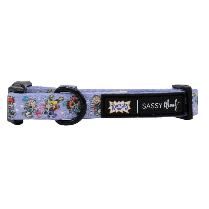 The Sassy Woof Dog Collar - Nickelodeon Rugrats™ features a lavender design with cartoon characters, black hardware, and a joint label—ideal for fans of 90s-inspired pet accessories.