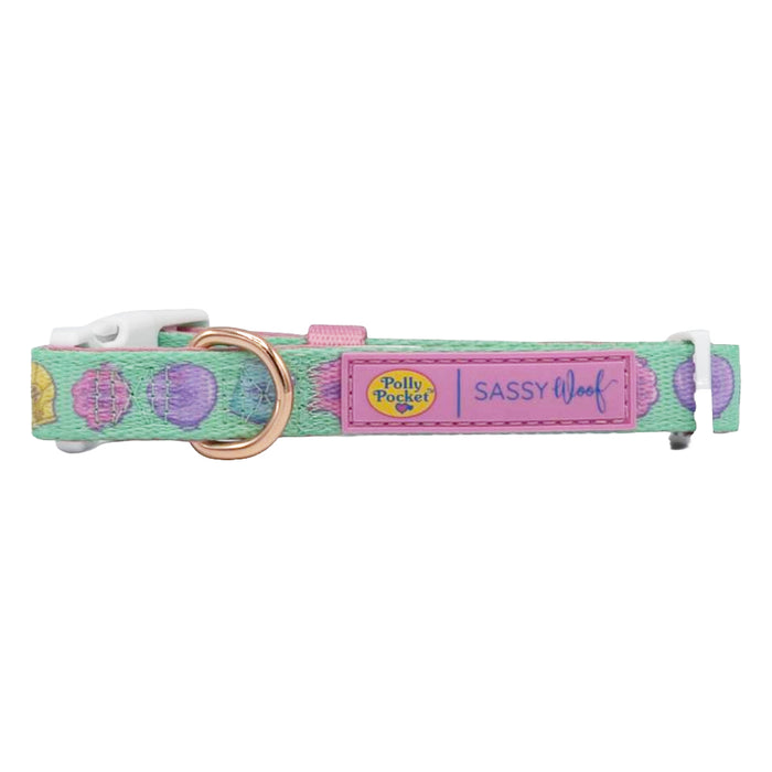 The Sassy Woof Dog Collar - Polly Pocket™ features pastel green with colorful circles, a gold D-ring, white plastic buckle, brand labels, and an adjustable fit for your pup—all displayed on a pink background.