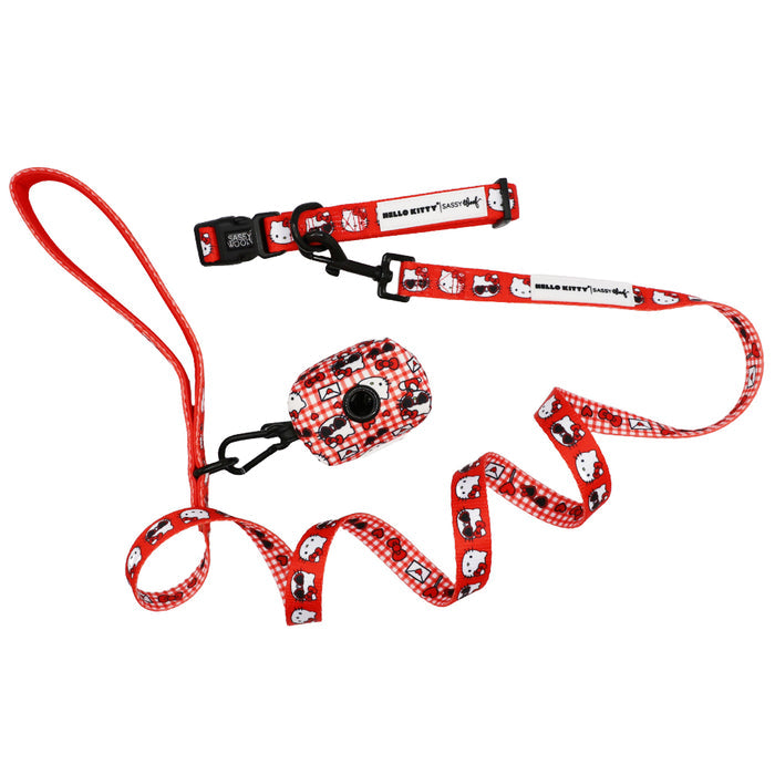 The Sassy Woof Dog Collar Three Piece Bundle - Hello Kitty® Red Classic features a matching collar, leash, and bag with white Hello Kitty faces and a red checkered design from the Sanrio Valentine collection, shown on a white background.