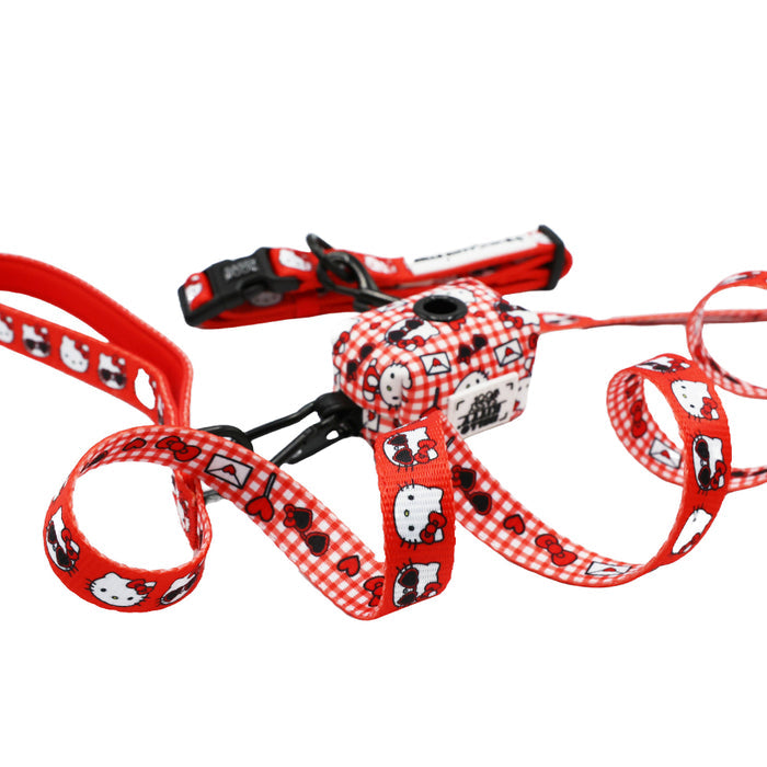 The Sassy Woof Dog Collar Three Piece Bundle - Hello Kitty® Red Classic features a red Hello Kitty-themed design with white and black cat faces, red hearts, and checkered patterns on the straps. Part of the Valentine collection, this set includes adjustable buckles and a leash attachment clip—making it a charming choice for Sanrio fans and their furry companions.