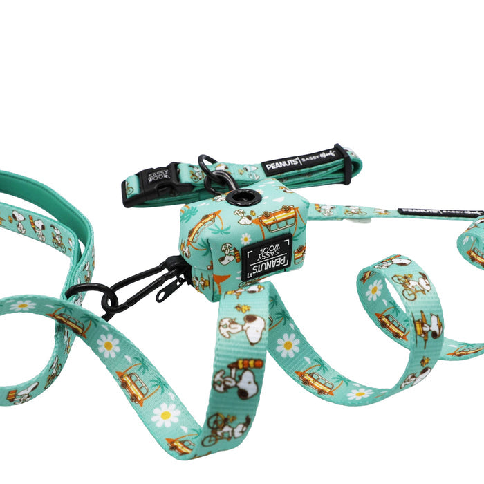 A teal Dog Collar Three Piece Bundle from Sassy Woof's Peanuts™ Road Tripping collection is shown coiled on a white background, featuring charming cartoon designs of Snoopy, Woodstock, white daisies, and a camper van—perfect adventure gear for dogs.