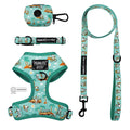 The Sassy Woof Dog Four Piece Bundle - Peanuts™ Road Tripping includes an adjustable harness, leash, collar, and poop bag holder with playful Snoopy, trees, and cars prints—perfect for a fun dog adventure.