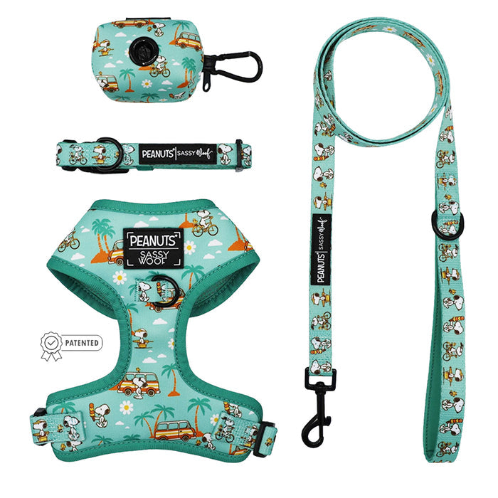 The Sassy Woof Dog Four Piece Bundle - Peanuts™ Road Tripping includes an adjustable harness, leash, collar, and poop bag holder with playful Snoopy, trees, and cars prints—perfect for a fun dog adventure.