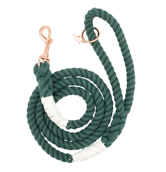 The Sassy Woof Dog Rope Leash - Emerald is a forest green cotton leash with white wrapped accents, plus a gold-colored clasp and ring.