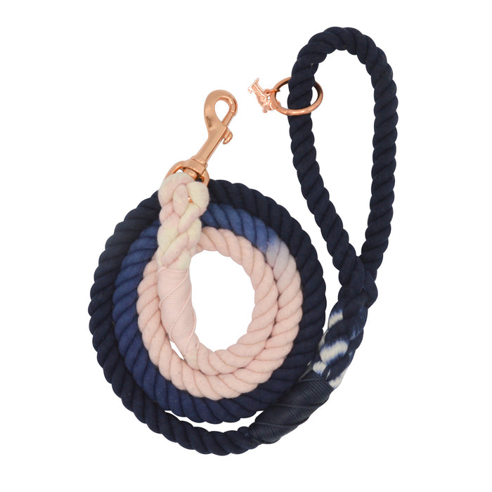The Dog Rope Leash - Moonlight by Sassy Woof features hand-crafted twisted sections in navy blue, pink, white, and indigo tie-dye for a colorful pattern, finished with a sleek gold clip for extra style.