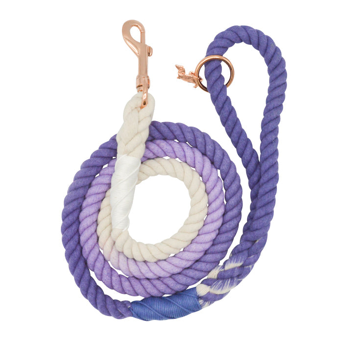 The Sassy Woof Dog Rope Leash - Ombre Purple features a hand-crafted gradient design, transitioning from white to light and dark purple, and is finished with a stylish rose gold clasp.