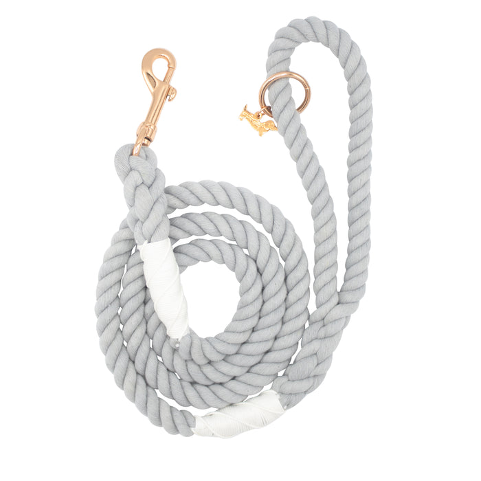The Sassy Woof Dog Rope Leash - Serenity is a coiled light gray cotton leash with rose gold hardware, a matching ring, and white wraps near both ends.