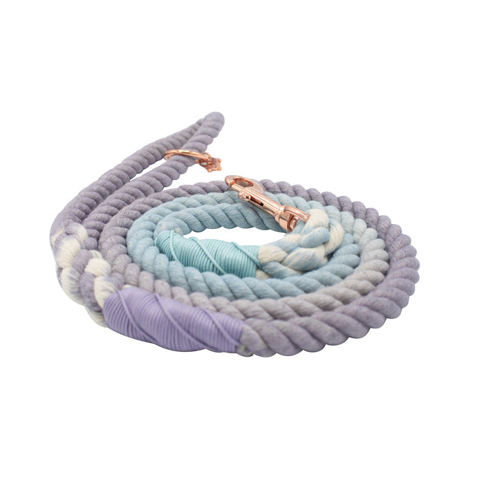 The Sassy Woof Dog Rope Leash - Skyfall features a hand-crafted ombre design in pastel purple, blue, and white, accented with a rose gold clip and dog charm.