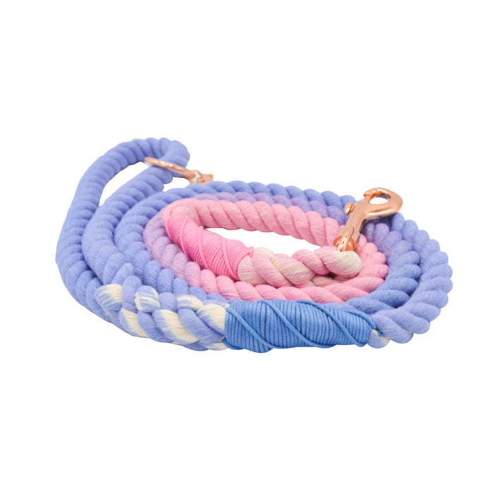 The Sassy Woof Dog Rope Leash - Victoria features a sturdy coiled rope design, rose gold hardware, and a pastel ombre gradient in purple, pink, blue, and cream, shown isolated on a white background.