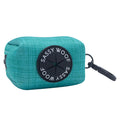 The Sassy Woof Dog Waste Bag Holder - Napa features teal neoprene, a black circular opening with “Sassy Woof” in white, and a black clip for easy carrying—Napa Valley inspired style for your walks.