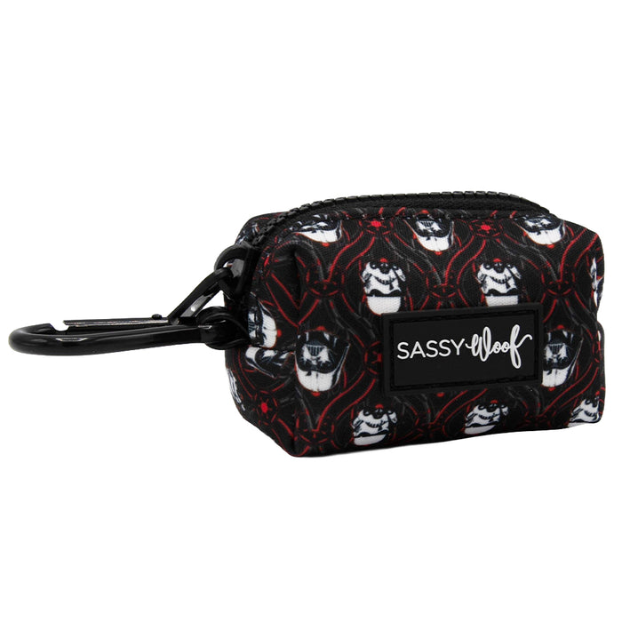 The Sassy Woof Dog Waste Bag Holder - STAR WARS™ The Dark Side is a small black neoprene pouch with a zipper, leash clip, and Sassy Woof label, featuring white dog faces with red accents.