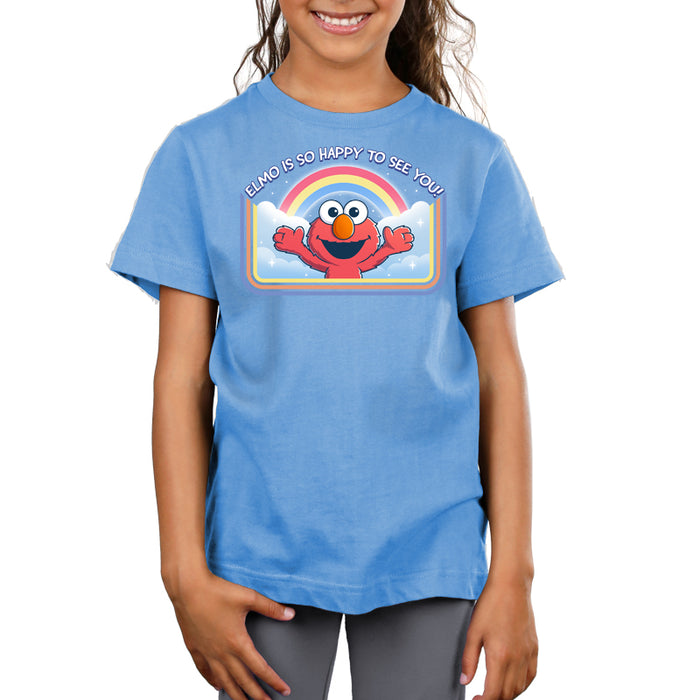 Premium Cotton T-shirt_TeeTurtle light blue Elmo Is So Happy To See You Premium Cotton T-shirt featuring Elmo from Sesame Street. He's smiling and has his arms wide as if he's going in for a hug. There's a rainbow and clouds behind him and  there is a retro style border along the sides and bottom. At the top is the text "Elmo Is So Happy To See You."
