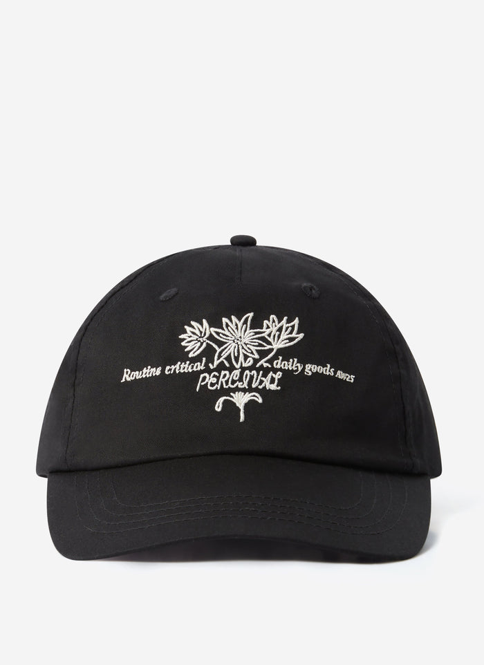 A front view of the black cotton Floral Embroidered Trucker Cap by Percival, shot against a plain white background.