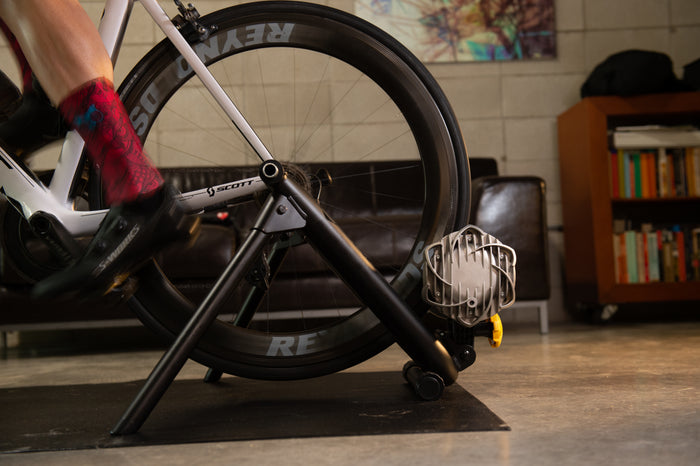 Athlete training on the Saris Fluid 2 Smart Equipped Trainer with Zwift on screen