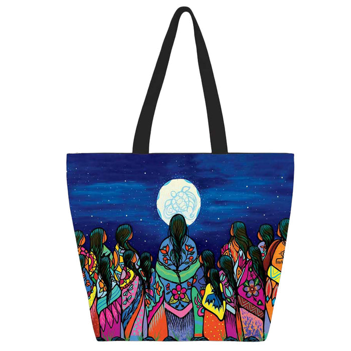 Tote bag with colorful design of people under a moonlit sky on a white background