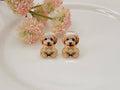 Golden doodle post earrings with gold-tone outline and cubic zirconia accents displayed on a white background from The Pink Doxie Boutique.
