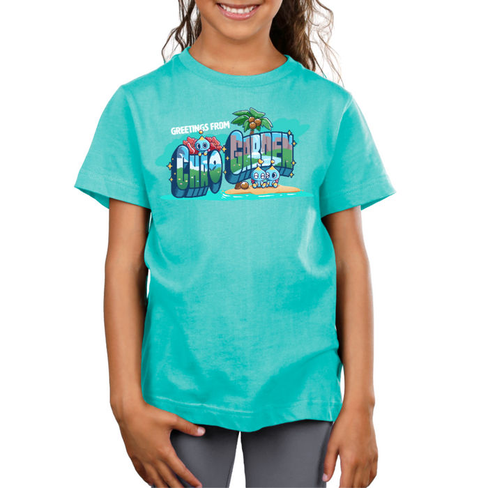 Premium Cotton T-shirt_TeeTurtle caribbean blue Greetings from Chao Garden Premium Cotton T-shirt featuring a vintage postcard design with cute little chao guys on an island with a coconut tree. There is text that reads "Greetings from" at the top and below there is a landscape visible in the bubble letters that spell "Chao Garden"