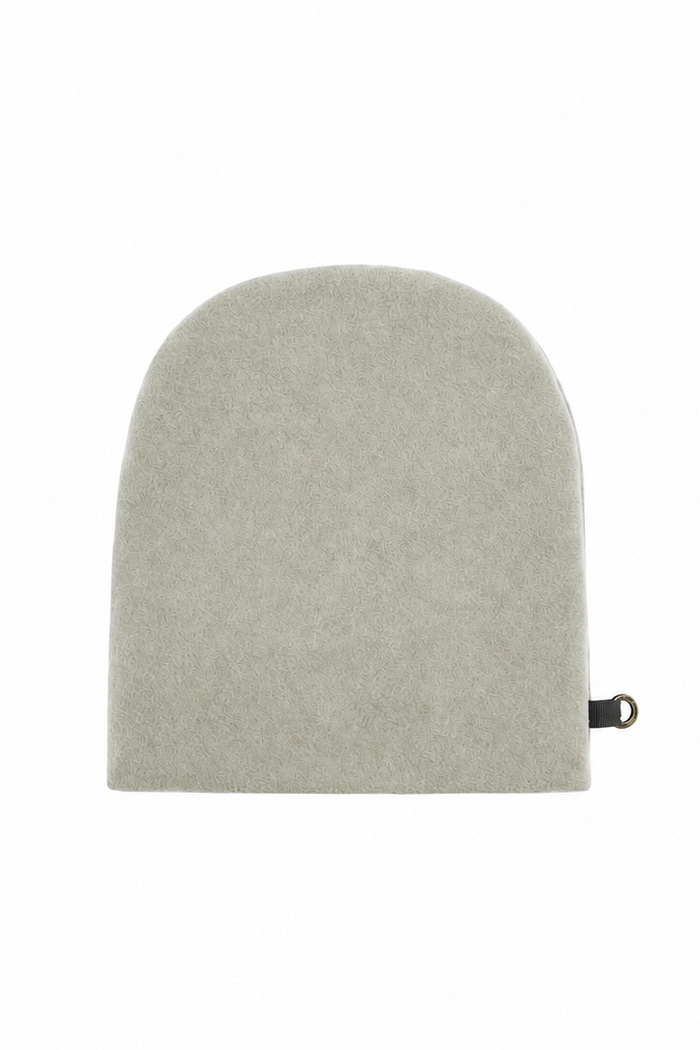 A beige fleece wool cap with a small black tag on the side, photographed against a solid white background.