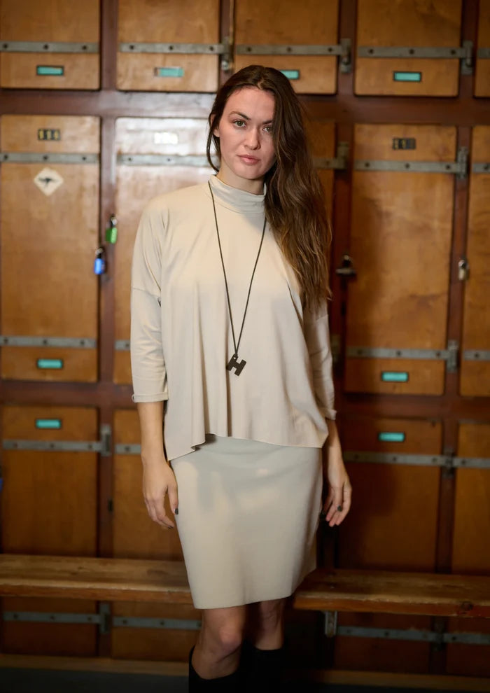 Woman standing in front of wooden lockers